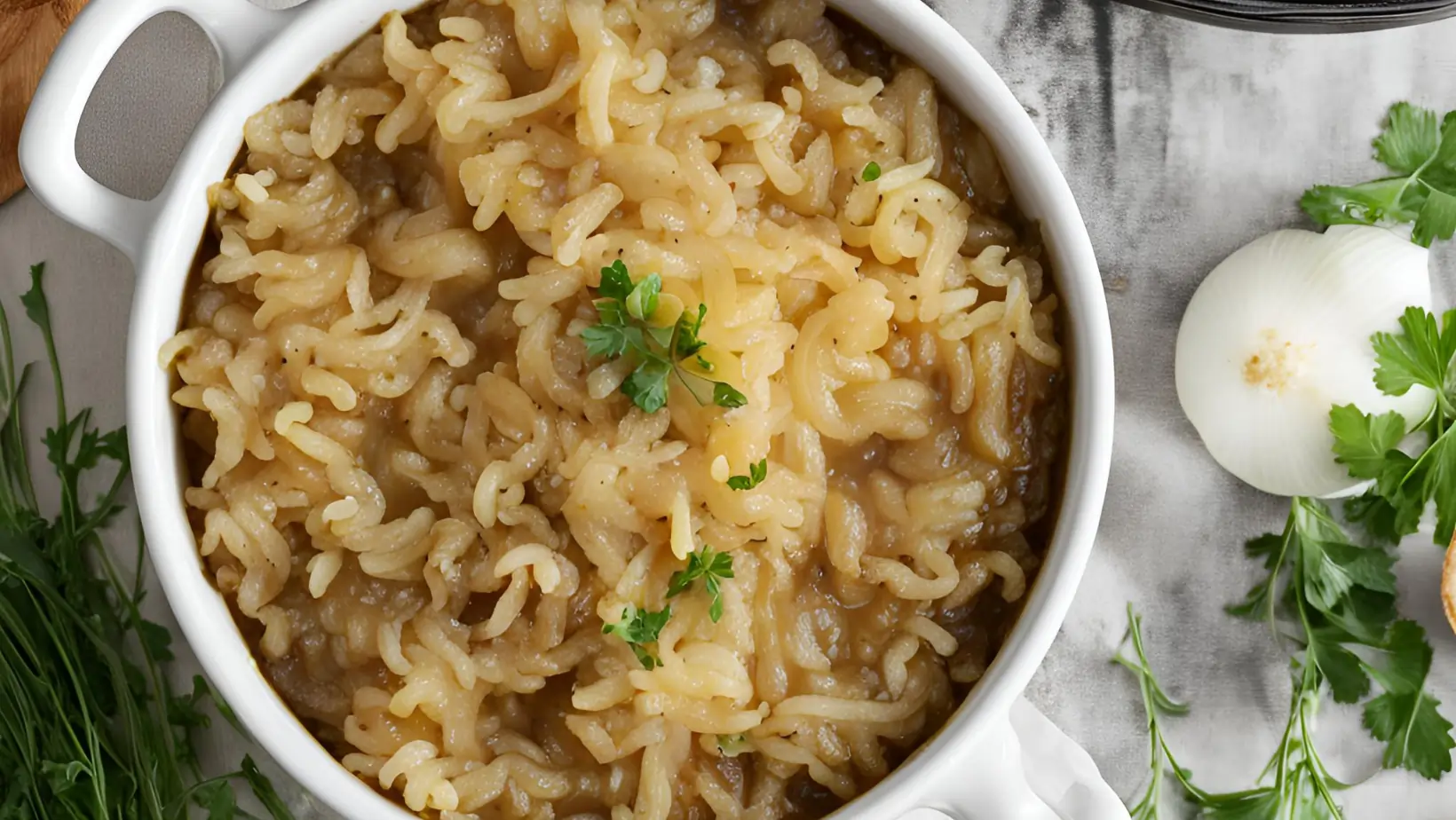 A bowl of rice French onion soup with melted cheese and toasted bread.